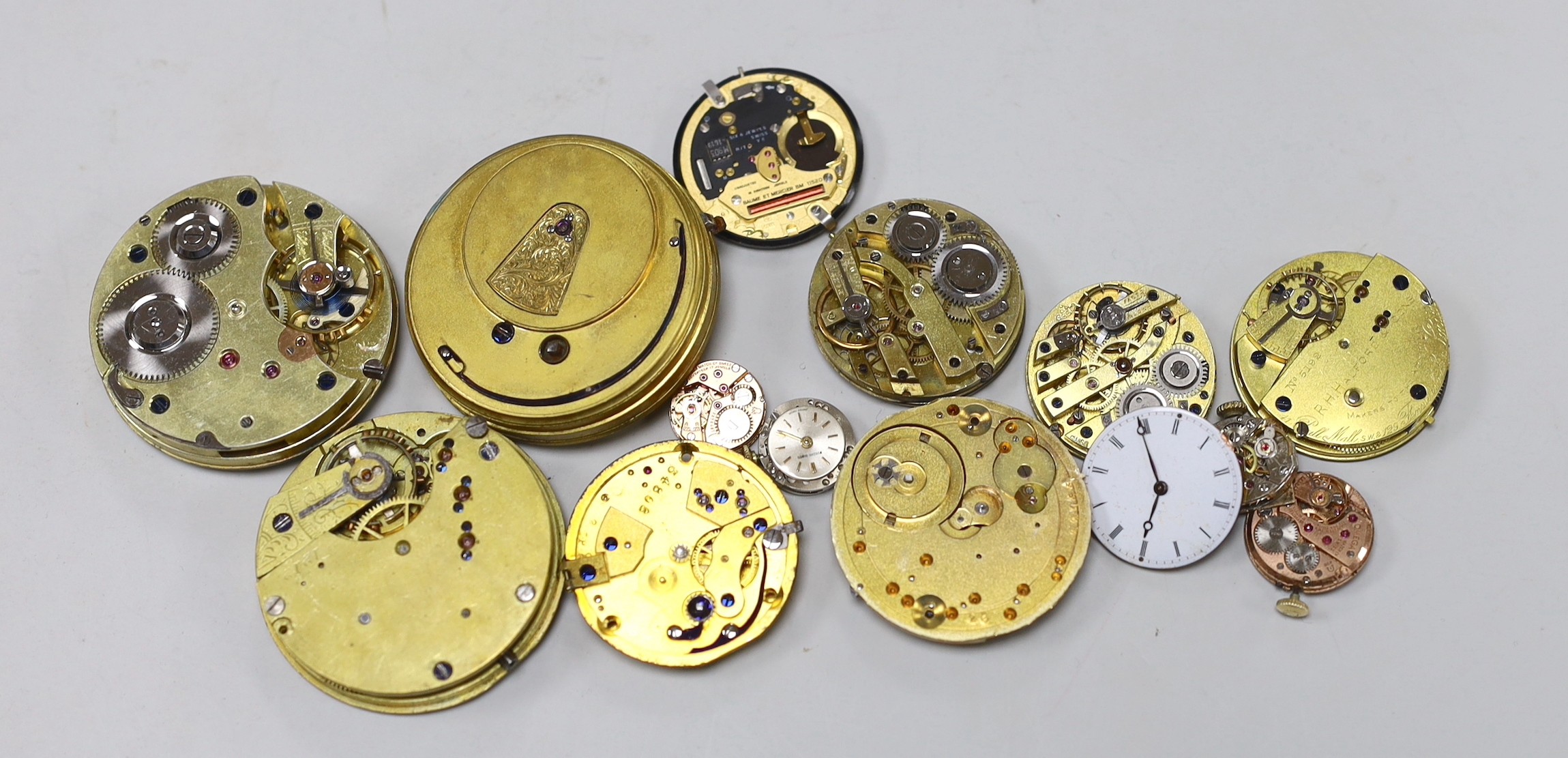 Various pocket and wrist watch movements and dials.